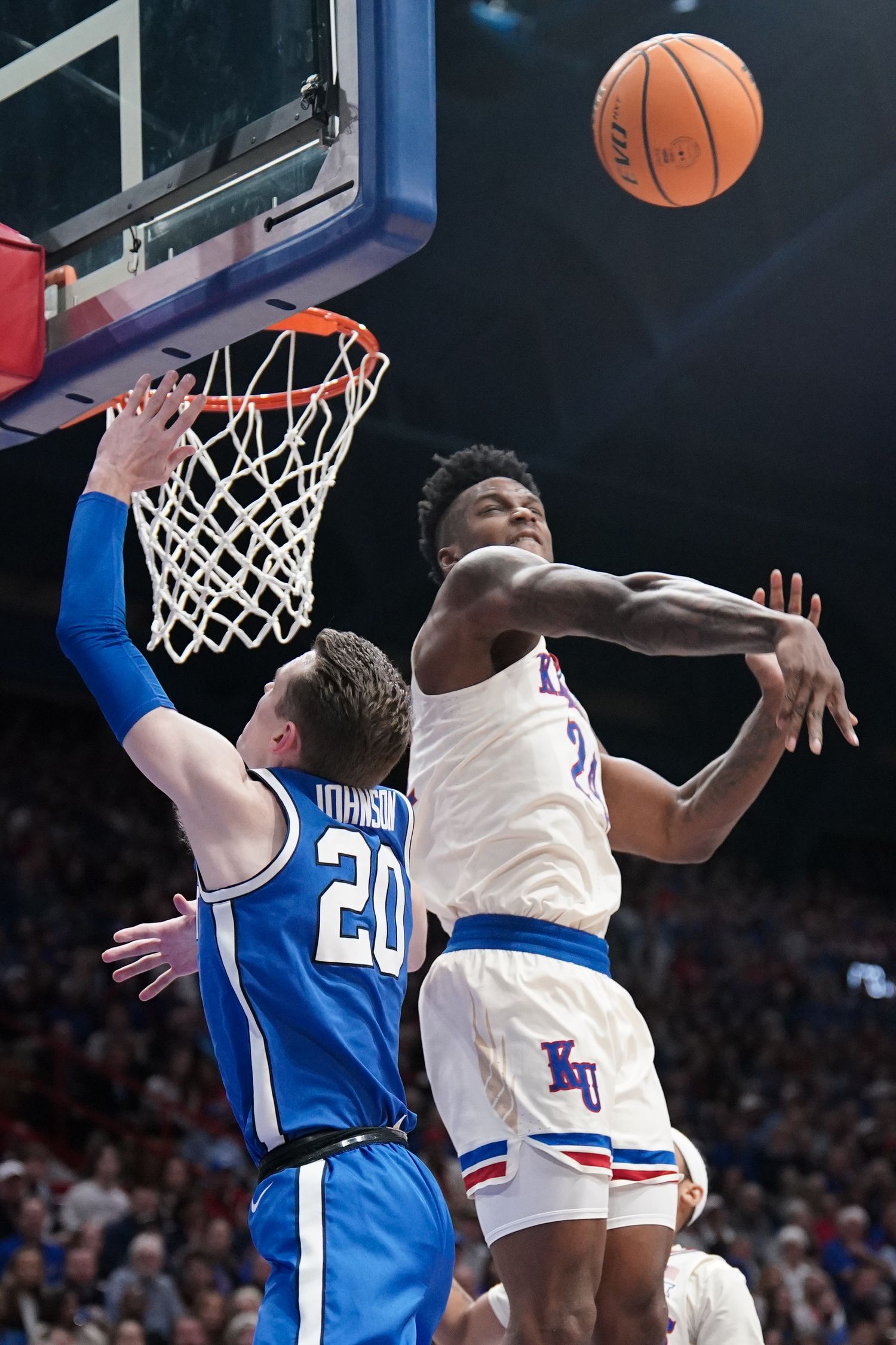Feb 27, 2024; Lawrence, Kansas, USA; Kansas Jayhawks forward K.J. Adams Jr. (24) blocks a shot by Brigham Young Cougars guard Spencer Johnson (20) during the first half at Allen Fieldhouse. Mandatory Credit: Denny Medley-USA TODAY Sports  